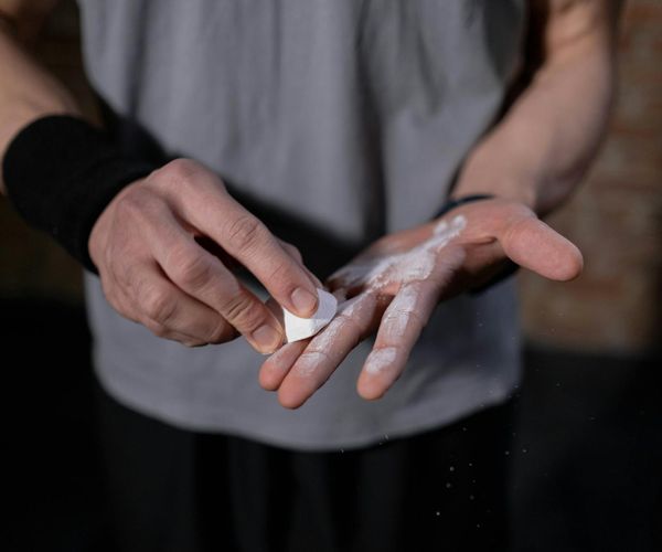 Close-up of a person's hands gripping a pull-up bar, showing focus.
